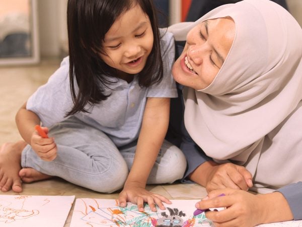 Mother with daughter playing on floor