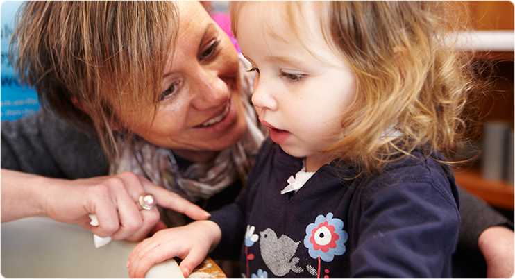 Woman with young girl smiling